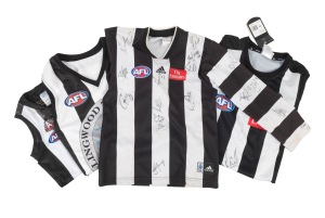 COLLINGWOOD: A group of four late 1990s/early 2000s guernseys, comprising a long-sleeved boys guernsey with no fewer than twenty original signatures, a short-sleeved size M guernsey with two signatures, and two others.