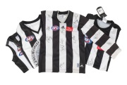 COLLINGWOOD: A group of four late 1990s/early 2000s guernseys, comprising a long-sleeved boys guernsey with no fewer than twenty original signatures, a short-sleeved size M guernsey with two signatures, and two others.