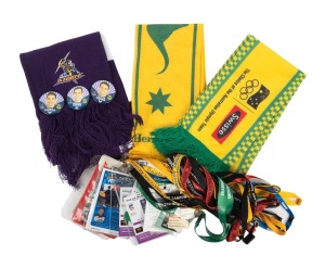 A collection remainder comprising two Socceroos scarves, a Melbourne Storm scarf with three button badges, and nineteen motorsport lanyards. (25 items)