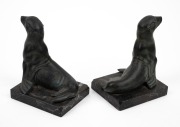 A pair of French Art Deco patinated spelter seal bookends on marble bases, signed "M. FONT", circa 1925, 13cm high. - 2