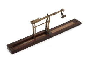 A. WILKINSON antique brass and timber sovereign scales with original lithograph paper instructions, 19th century, the case 15cm long when closed.