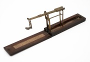 A. WILKINSON antique brass and timber sovereign scales with original lithograph paper instructions, 19th century, the case 15cm long when closed. - 2