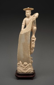 A vintage Chinese carved ivory statue of a fisherman hauling his net, mounted on a carved timber stand, early 20th century, 26cm high overall.