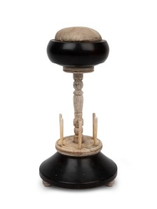 An antique whalebone and ebony sewing tidy with pin cushion top, mid 19th century, 22cm high.