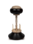 An antique whalebone and ebony sewing tidy with pin cushion top, mid 19th century, 22cm high.