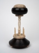 An antique whalebone and ebony sewing tidy with pin cushion top, mid 19th century, 22cm high. - 2