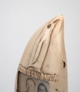 An unusual scrimshaw whale's tooth with carved penguin decoration and inset black and white photo portraits, mounted on later bespoke stand, circa 1930s, ​​​​​​​the tooth 15.5cm high. - 2