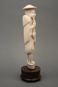 A Chinese carved ivory statue of an old fisherman, mounted on a turned timber plinth, 19th/20th century, ​​​​​​​25cm high overall. - 2