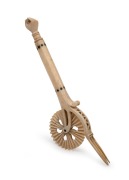 An antique carved whalebone jagging wheel pie crimper with carved fist finial, 18th/19th century, ​​​​​​​18.5cm long.