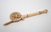 An antique carved whalebone jagging wheel pie crimper with carved fist finial, 18th/19th century, ​​​​​​​18.5cm long. - 2