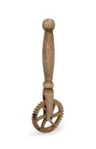 An antique carved whalebone jagging wheel pie crimper with turned handle, 19th century, 14.5cm long.