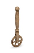 An antique carved whalebone jagging wheel pie crimper with turned handle, 19th century, ​​​​​​​14.5cm long.