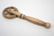 An antique carved whalebone jagging wheel pie crimper with turned handle, 19th century, ​​​​​​​14.5cm long. - 2