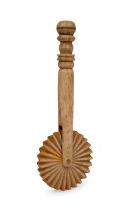 An antique carved whalebone jagging wheel pie crimper with turned handle, 19th century, ​​​​​​​16.5cm long.