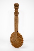 An antique carved whalebone jagging wheel pie crimper with turned handle, 19th century, ​​​​​​​16.5cm long. - 2