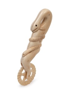 An antique carved whalebone jagging wheel pie crimper with serpent decoration, 19th century, 11.5cm long.