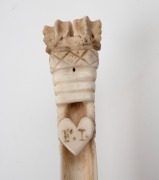 An antique carved whalebone apple corer carved with sweetheart and initials "F.I.", 19th century, 14.5cm long. - 3