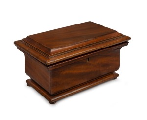 An antique mahogany tea caddy fitted with two lidded compartments with ivory knobs, 19th century, 16cm high, 29.5cm wide, 19cm deep.