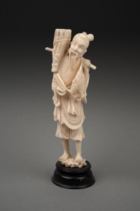A vintage Chinese carved ivory statue of a fisherman, mounted on timber base, early to mid 20th century, 18cm high overall.