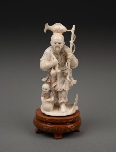 A vintage Japanese carved ivory okimono figural group with hand-coloured decoration, mounted on a timber base, 20th century, 14cm high overall.