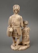 An antique Japanese carved ivory and bone okimono figural group, Meiji period, 19th/20th century, ​​​​​​​16cm high. - 2