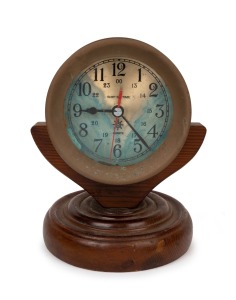 SHIP'S TIME maritime bulkhead clock in brass case with quartz movement, mounted on an attractive turned timber stand, 20th century, 24cm high overall.