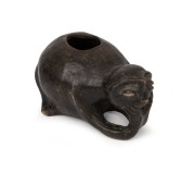 An antique pottery Moche jug with kneeling figure decoration and black painted finish, Peruvian origin, 9cm high, 17cm long.