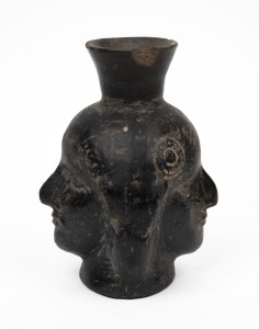 A pottery double sided face jug, Peruvian origin, 16cm high.