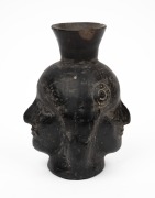 A pottery double sided face jug, Peruvian origin, 16cm high.