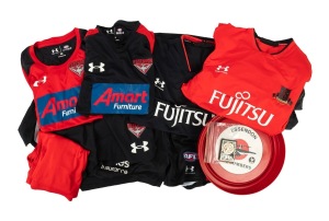 ESSENDON: A collection of 2020s club apparel comprising 1 jacket, 5 shirts, and 3 pairs of shorts (mostly AFL "On-Field" issues), together with a circa 1970s Essendon Bombers Courage Draught plastic beer tray and four 1960s "Essendon Club" membership pass