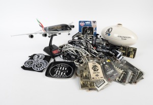 COLLINGWOOD: A diverse group of branded memorabilia, mostly post-2000s, including a 1:200 scale Airbus A380-800, two flags (2010 and 2023 Premierships), a "100 Magnificent Years" ceramic football, an ashtray, some medallions, several cloth badges, thirty-