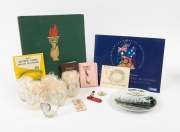 A group of 1956 Melbourne Olympics items, including an "Embassy Olympic Notebook" signed by no fewer than twenty-five Olympians, a set of six drinking glasses, a plate, a ticket, a wooden toy, and several others. (qty.)