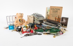 A diverse accumulation of golf items, including a 2011 Augusta Masters pass, course guides, scorecards, commemorative spoons, pin badges, and assorted knick-knacks. (qty.)