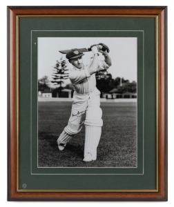 DON BRADMAN: Framed and glazed photograph of Bradman posed with bat, featuring Bradman's original signature in permanent marker; 60 x 50cm overall.