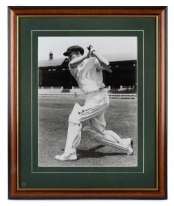 DON BRADMAN: Framed and glazed photograph of Bradman at the Adelaide Oval, featuring Bradman's original signature in permanent marker; 60 x 50cm overall.