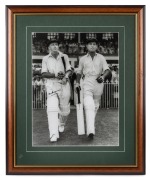 DON BRADMAN: Framed and glazed photograph of Bradman stepping out to bat alongside Jack Fingleton, featuring Bradman's original signature in permanent marker; 60 x 50cm overall.