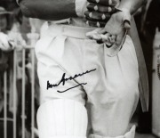 DON BRADMAN: Framed and glazed photograph of Bradman stepping out to bat alongside Jack Fingleton, featuring Bradman's original signature in permanent marker; 60 x 50cm overall. - 2