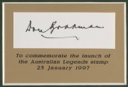 DON BRADMAN: Display incorporating a nice example of Bradman's pen signature on piece, a 1997 Australia Post "Australian Legends" Bradman 45c stamp sheet, and two photographs; plaque reads "To commemorate the launch of the Australian Legends stamp - 23 Ja - 2