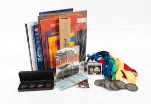 A group of Sydney Olympics items including eighteen original tickets, complete set of sixteen Official Olympic Daily magazines, Official Spectator Guide (2), The Official Souvenir Book (hardcover), several pins, and others, plus 1984 "Carry The Flame" LP,