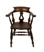 An antique English elm and beech smoker's bow chair, 19th century, ​​​​​​​84cm high, 68cm across the arms.