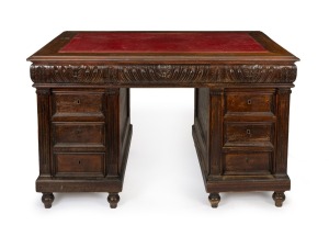 An antique French walnut twin pedestal desk with red leather insert top and Ionic carved pilasters, 19th century, 82cm high, 137cm wide, 86cm deep.