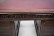 An antique French walnut twin pedestal desk with red leather insert top and Ionic carved pilasters, 19th century, 82cm high, 137cm wide, 86cm deep. - 4