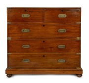 An antique Colonial Anglo-Indian teak two sectional military campaign chest with flush fitted brass hardware and ebony escutcheons, mid 19th century, 105cm high, 112cm wide, 51cm deep.
