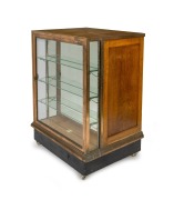 An antique Tasmanian oak and copper bound shop display cabinet with four large drawers and unusual slimline display case front, circa 1900, electrified and on later casters, 104cm high, 77cm wide, 62cm deep. - 2