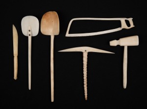 A set of antique carved whalebone and whale's tooth miniature hand tools, 19th century, (6 items), the largest 15cm long.