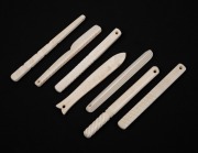 Set of seven sailor made carved marine ivory teethers, 19th century, ​​​​​​​the largest 11.5cm long.