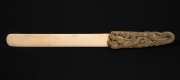 An antique Japanese carved whalebone page turner with gilt brass dragon handle, Meiji period, 19th century, ​​​​​​​28cm long.