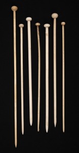 Seven assorted antique whalebone knitting needles with turned finial tops, 19th century, ​​​​​​​the largest 28cm long.
