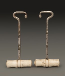 A pair of antique boot jacks with whalebone turned handles, 19th century, 18cm high.