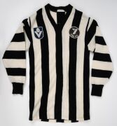 COLLINGWOOD: A late 1970s long-sleeved guernsey, VFL logo and "Yakka" patches on front, number 19 on back; John Wise, Laurie Sandilands, and Craig Davis wore this number during the seasons when this guernsey configuration was used. - 2